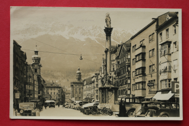 AK Innsbruck / 1937 / Strassenansicht / Friseur / Drogerie Parfumerie / Autobus / Apotheke / Breinössl / Geldwechsel / Auto Taxi / Triol